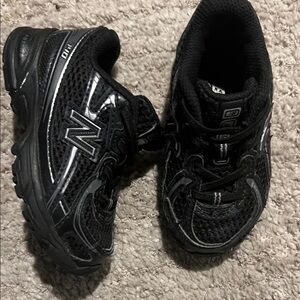 New Balance Kids Black Mesh Athletic Sneakers with Silver Accents